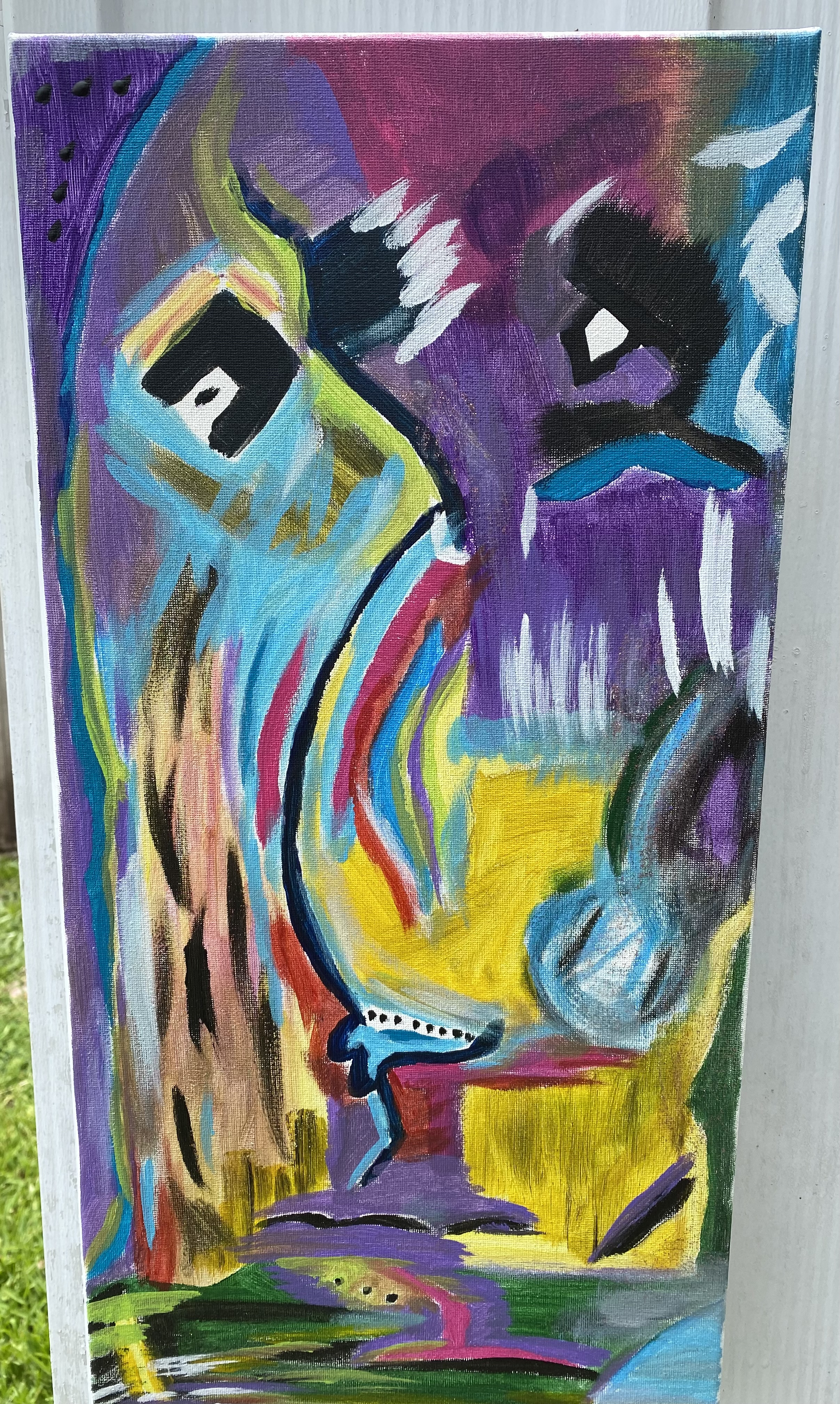 10in x 20in artist's loft canvas with an abstract colorful face. brush strokes were rapid and fast. the stroke were made up of the following colors: violet, yellow, nude, pink, azul blue, hunter green, white, brilliant red, and black. 