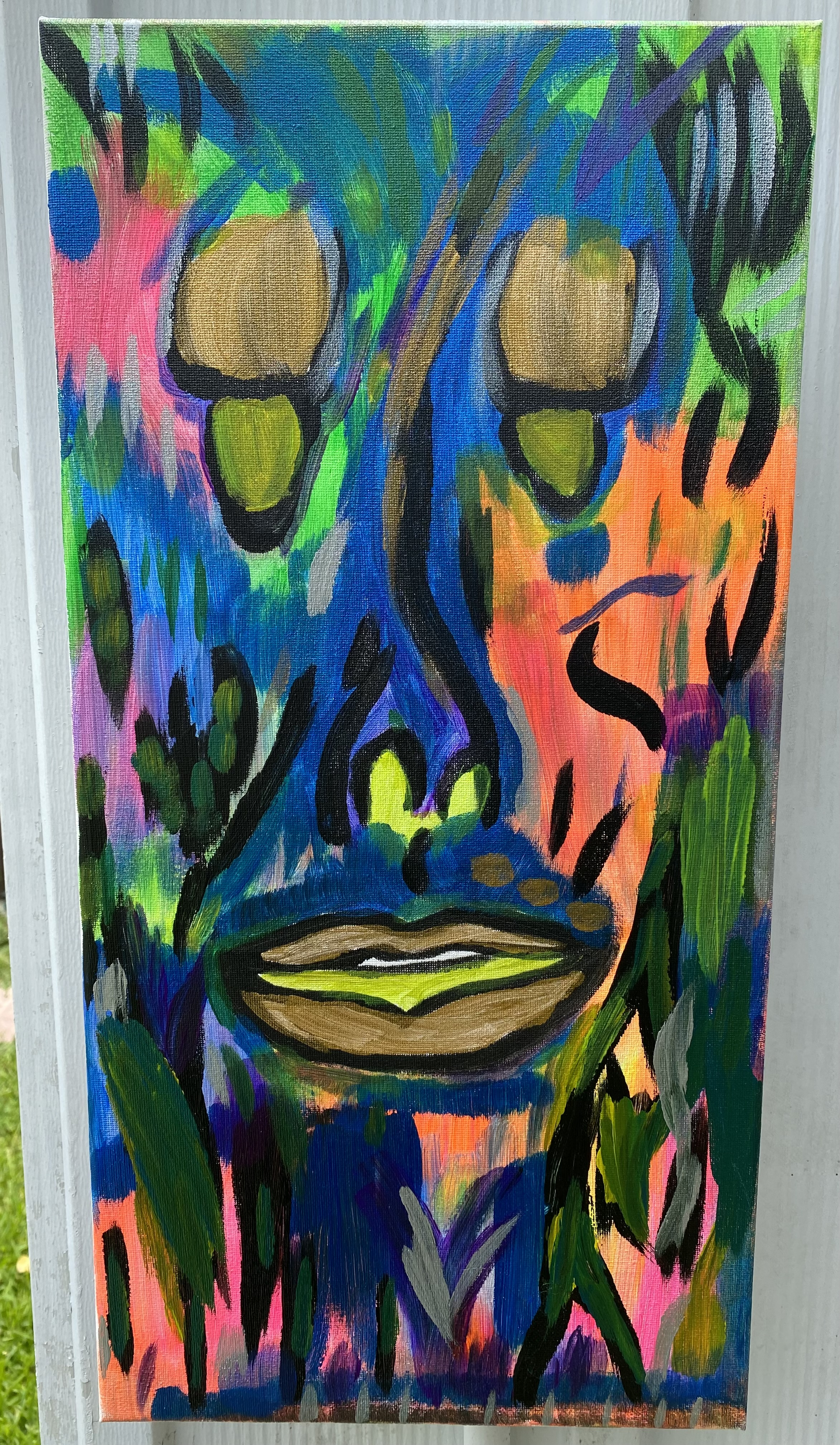 10in x 20in canvas with a woman crying gold and yellow tears. rapid brush strokes of vibrant neon arcylic paints are scattered throughout. no woman was hurt during the creation of this painting. 