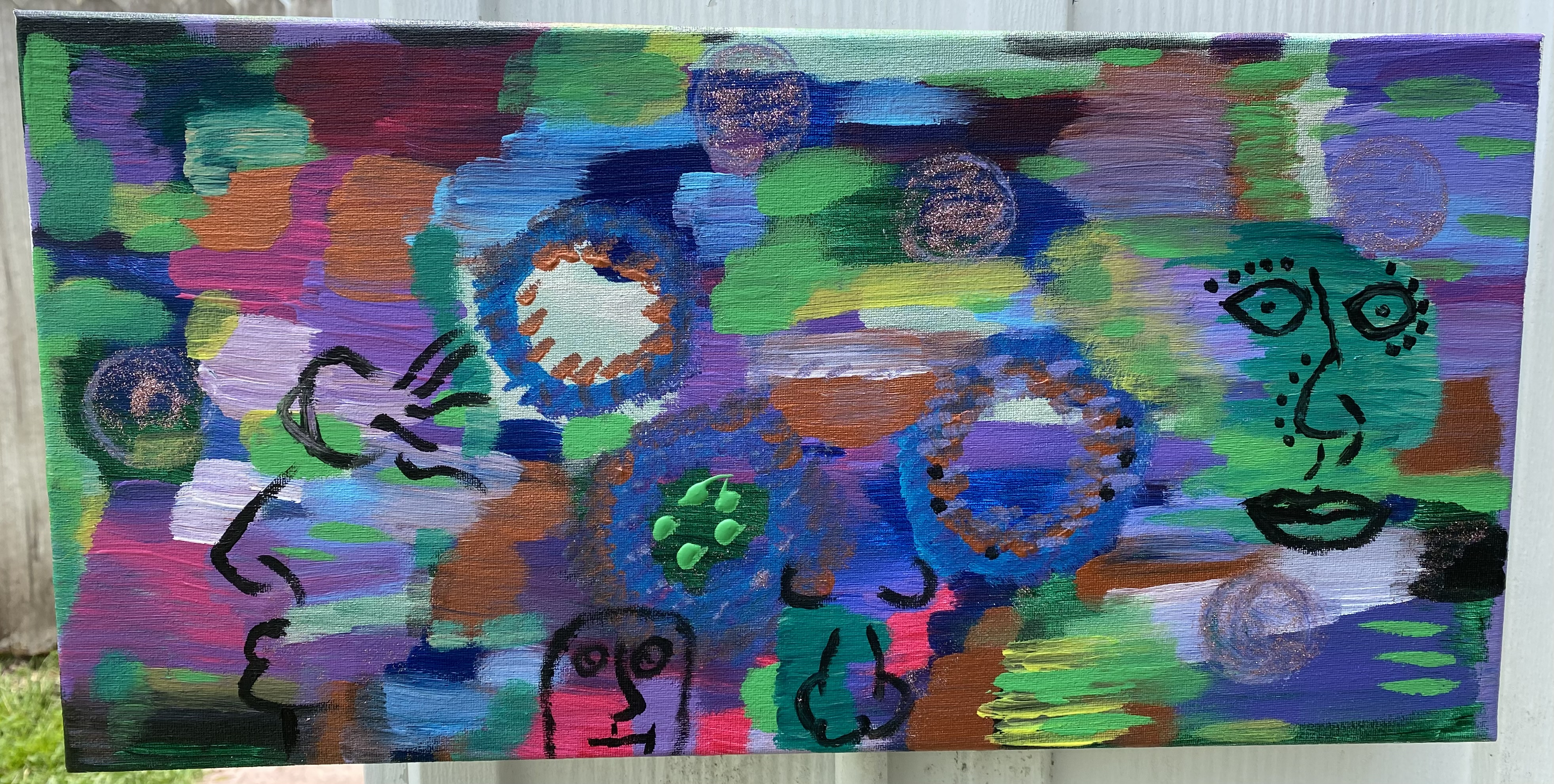 vibrant, colorful 10in x 20in canvas painting with four abstract faces and circles of glitter.
